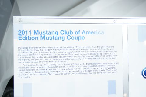 1993 Ford Taurus - A sign details the features of the 2011 Mustang Club of America Edition Mustang Coupe.