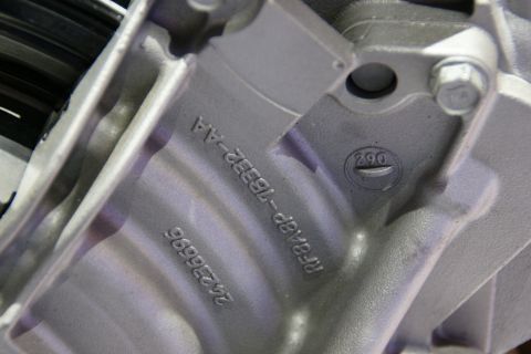 1993 Ford Taurus - Metal engine component with visible casting and identification numbers.