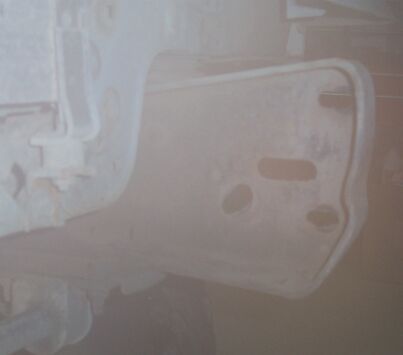 1990 Ford Bronco - For reference, stock front framerail before any mods. (Sorry for the smoky pic)