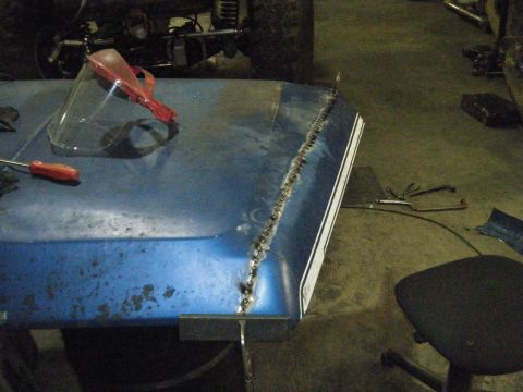 1978 Ford Bronco - A blue hood with a white stripe and a visible weld seam is shown, with tools nearby.