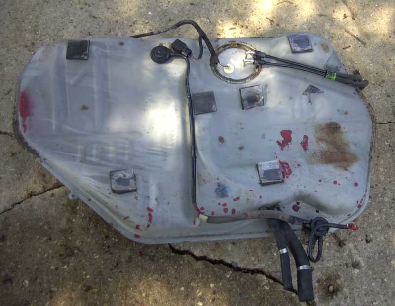 Fuel tank with hoses and electrical connector