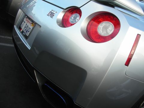 1998 Ford Crown Victoria - Rear view of a silver Nissan GT-R, distinctive round taillights and the GT-R emblem.
