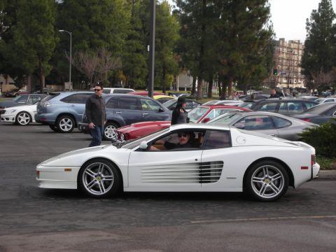 1998 Ford Crown Victoria - White Ferrari Testarossa with a driver visible, parked among other vehicles.