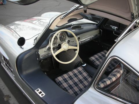 1998 Ford Crown Victoria - The interior of a classic Mercedes-Benz 300 SL Gullwing features plaid seat upholstery and a distinctive white steering wheel.