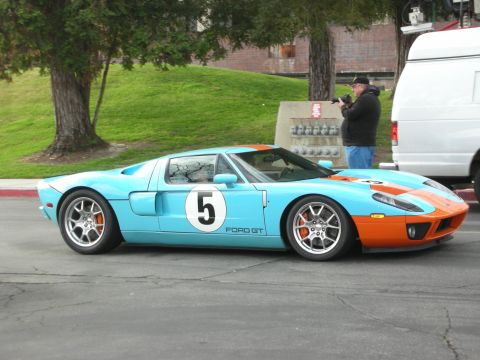 1998 Ford Crown Victoria - A light blue and orange Ford GT with racing stripes and the number 5 on the door is parked on asphalt.