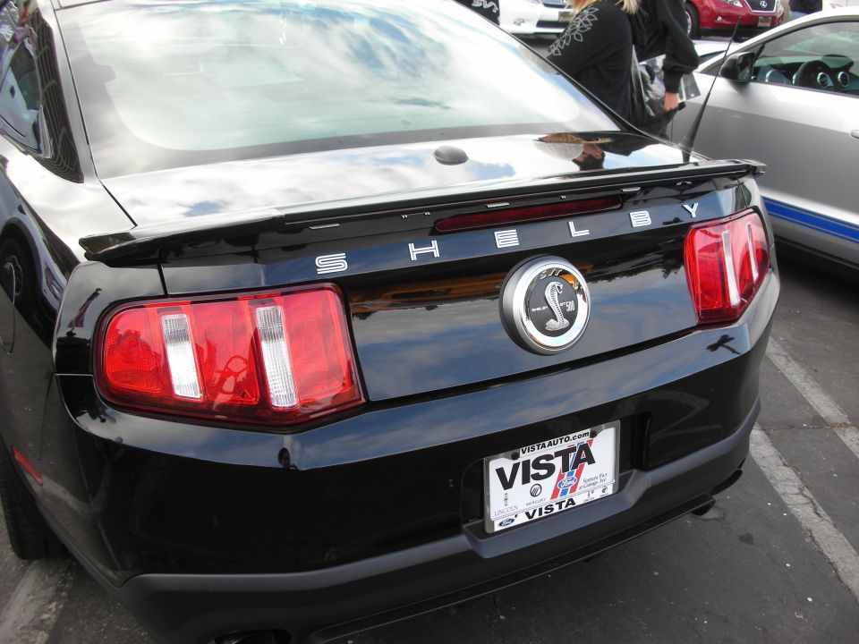 Black Shelby Mustang rear with cobra emblem and VISTA license plate frame