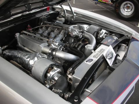 1998 Ford Crown Victoria - Custom engine bay twin turbochargers and a Ron Davis Racing Products radiator, with a brochure visible.