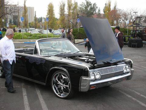1998 Ford Crown Victoria - Classic black convertible parked outdoors with its hood raised, revealing the engine bay.