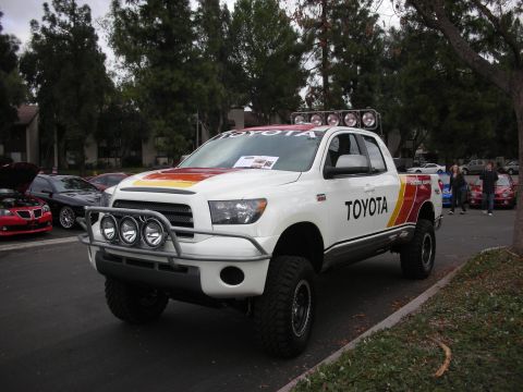 1998 Ford Crown Victoria - A customized Toyota Tundra pickup truck is parked next to other vehicles.