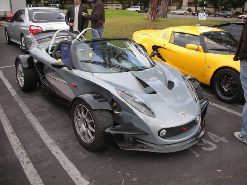 1998 Ford Crown Victoria - Two Lotus Elise sports cars are parked side-by-side in a parking lot.