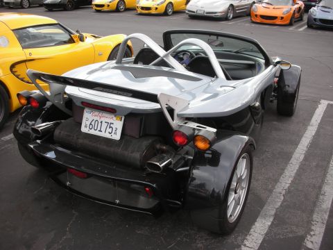 1998 Ford Crown Victoria - This Lotus Elise has a California license plate and is parked in a lot with other cars.