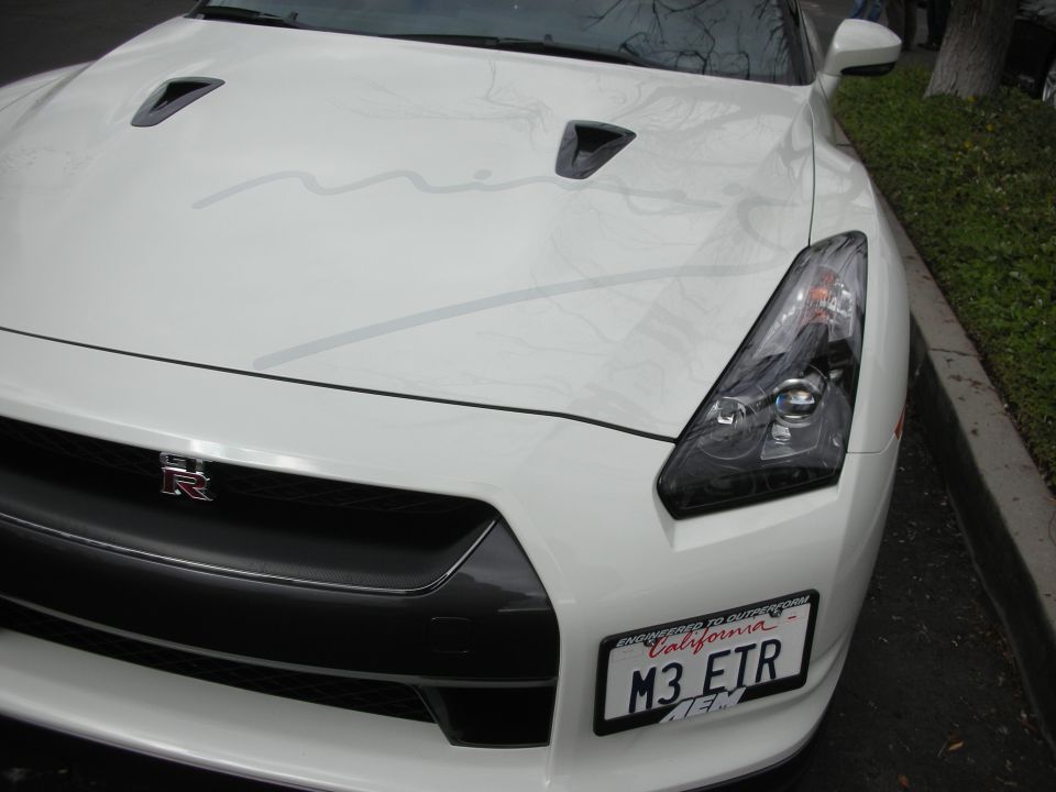 White Nissan GT-R front with 'R' badge and California license plate M3 ETR