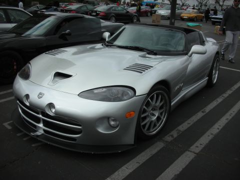 1998 Ford Crown Victoria - Silver Dodge Viper SRT-10 parked in a lot with other vehicles.