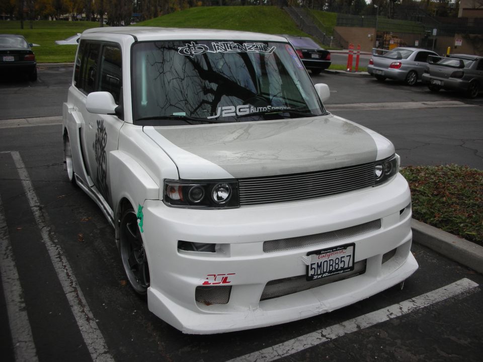 White Scion xB with custom body kit and decals, front view. License plate 5MOB857