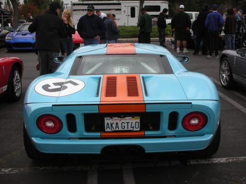 1998 Ford Crown Victoria - Blue and orange Ford GT with racing stripes and number 5 visible, parked at an outdoor event.