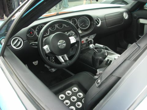 1998 Ford Crown Victoria - The interior of a sports car features a central console with a prominent gear shifter and carbon fiber accents.