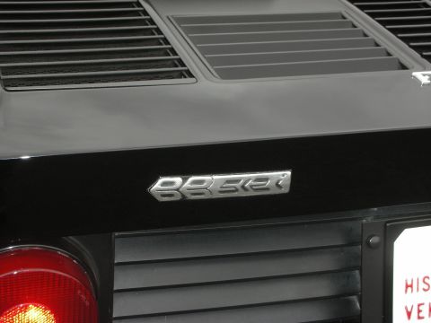 1998 Ford Crown Victoria - Silver 'BESSE' emblem on a black car's rear panel.