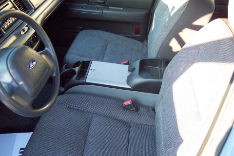 2001 Ford Crown Victoria - The interior of a 2001 Ford Crown Victoria, a gray cloth interior with a center console and bucket seats.