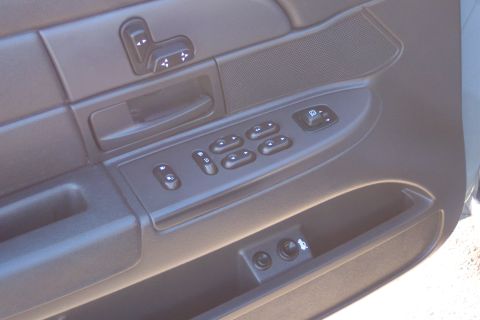 2001 Ford Crown Victoria - Close-up of a car's interior door panel, showing power window and lock controls.