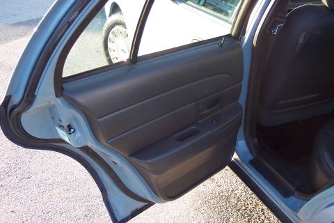 2001 Ford Crown Victoria - Interior view of a 2001 Ford Crown Victoria, focusing on the rear door panel and seat.