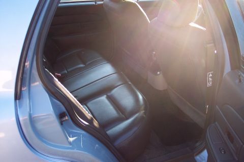 2001 Ford Crown Victoria - Interior view of a light blue sedan, showing the rear seats and door panel.