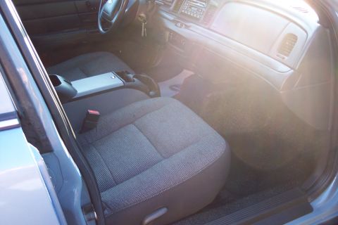 2001 Ford Crown Victoria - The interior of a 2001 Ford Crown Victoria, cloth seats and a standard dashboard layout.