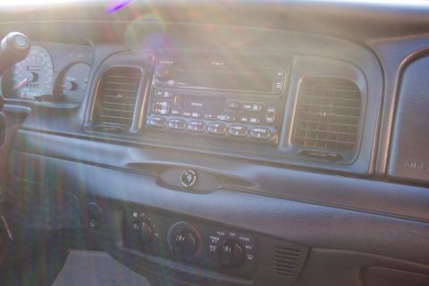 2001 Ford Crown Victoria - Interior view of a 2001 Ford Crown Victoria dashboard, showing the radio and climate controls.