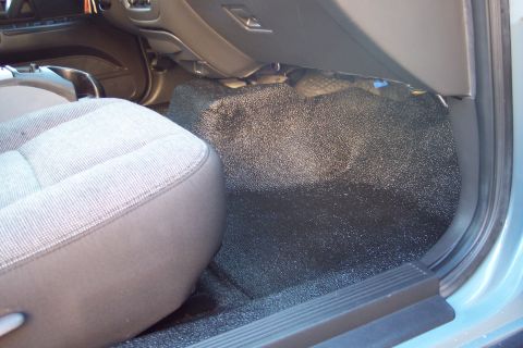 2001 Ford Crown Victoria - Close-up view of the passenger side interior, focusing on the seat and floor area.