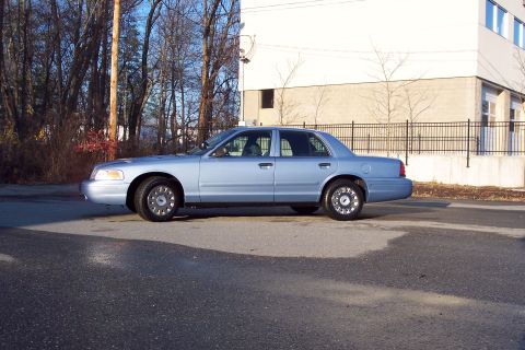 2001 Ford Crown Victoria - Side view of a 2001 Ford Crown Victoria sedan parked on a street.