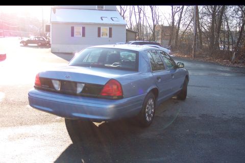 2001 Ford Crown Victoria - This 2001 Ford Crown Victoria is seen from the rear, parked on a street during the day.
