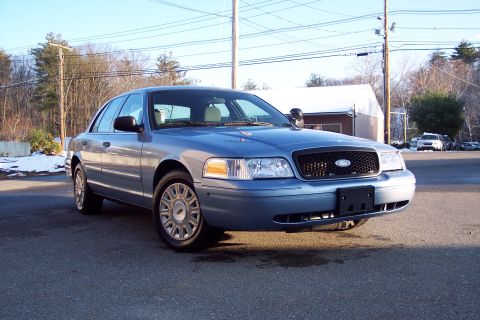 2001 Ford Crown Victoria - Blue 2001 Ford Crown Victoria sedan seen from a 3/4 front angle.