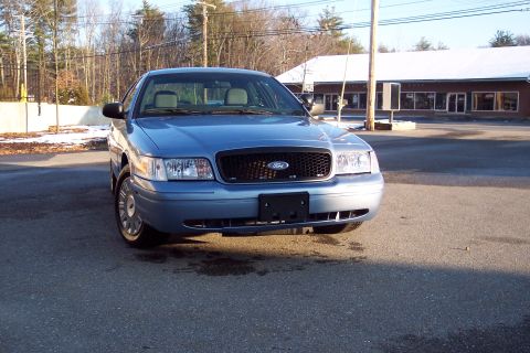 2001 Ford Crown Victoria - A blue 2001 Ford Crown Victoria is shown from the front in this photograph.