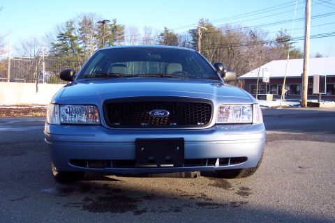 2001 Ford Crown Victoria - Front view of a blue 2001 Ford Crown Victoria, showing its grille and headlights.