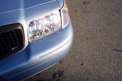 2001 Ford Crown Victoria - Front corner view of a blue 2001 Ford Crown Victoria, its distinctive honeycomb grille and clear headlight assembly.