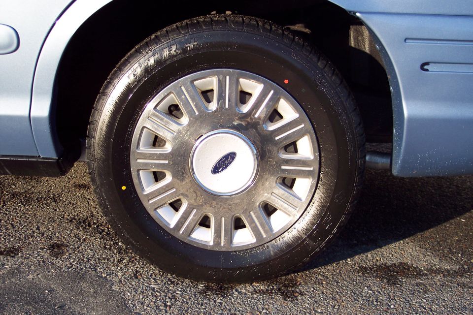Light blue 2001 Ford Crown Victoria wheel and fender