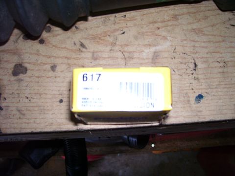 1991 Ford Bronco - A yellow box labeled with part number 617 sits on a wooden workbench.