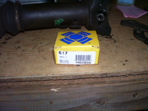 1991 Ford Bronco - A Precision brand part, likely for a drive shaft rebuild, sits on a wooden surface.