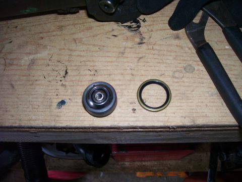 1991 Ford Bronco - Drive shaft bearing and seal laid out on a workbench, possibly for a rebuild.