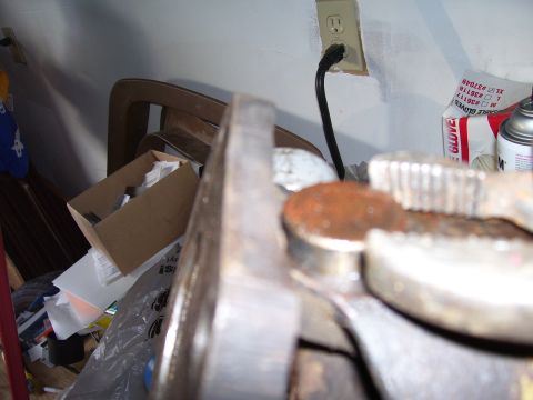 1991 Ford Bronco - A close-up view of a rusty vehicle part, likely related to a drive shaft rebuild.