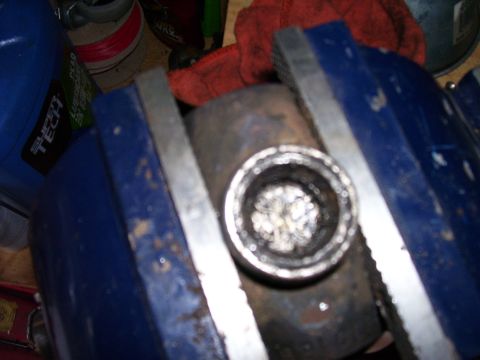 1991 Ford Bronco - A drive shaft component is secured in a vise, likely for a repair or rebuild.