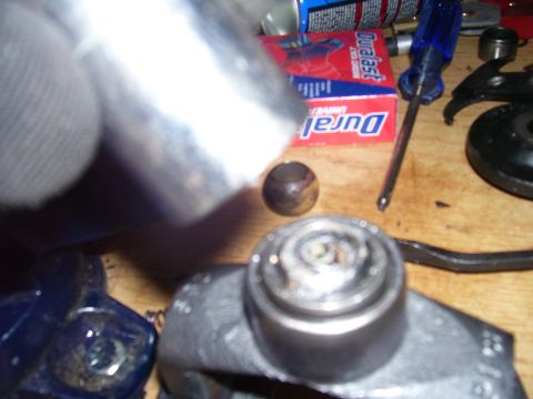 1991 Ford Bronco - A drive shaft part is shown on a workbench next to a Duralast box and tools, suggesting a repair or rebuild.