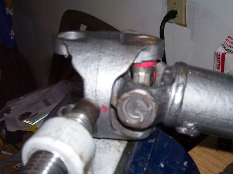 1991 Ford Bronco - A drive shaft component is examined, possibly for a rebuild, with a vise and tools visible.