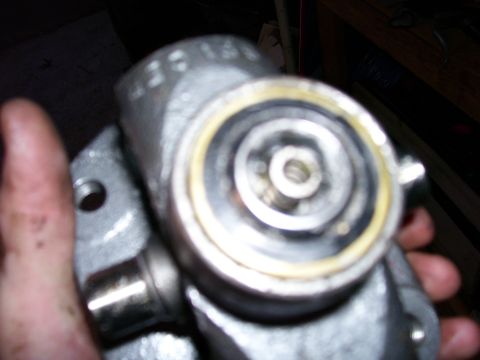 1991 Ford Bronco - Close-up of a metal automotive part, possibly a drive shaft component, with a yellow seal visible.