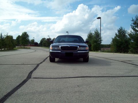 1999 Mercury Grand Marquis - Front view of a dark 1998 Mercury Grand Marquis parked in a lot.