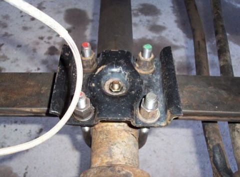 1990 Ford Bronco - On the passenger side I was able to use an old 8.8 spring plate with just a slight amount of reaming to the holes. This is how a spring pla…