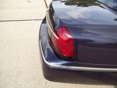 1999 Mercury Grand Marquis - Close-up of the rear tail light assembly on a dark blue sedan.