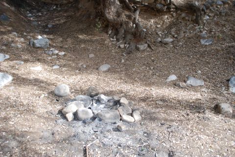 1996 Ford Bronco - A fire pit sits in a natural outdoor setting, surrounded by rocks and dirt.