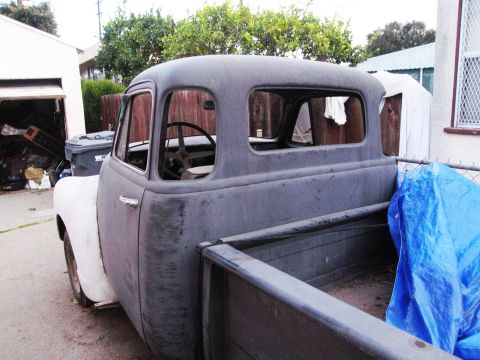 1986 Ford Bronco - This old pickup truck cab is in primer and appears to be undergoing restoration.