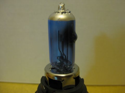 1994 Ford Thunderbird - A close-up view of a blue-tinted headlight bulb.