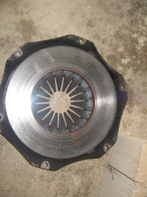 1978 Ford Bronco - A close-up view of a vehicle's clutch disc and pressure plate assembly, showing wear on the friction material.